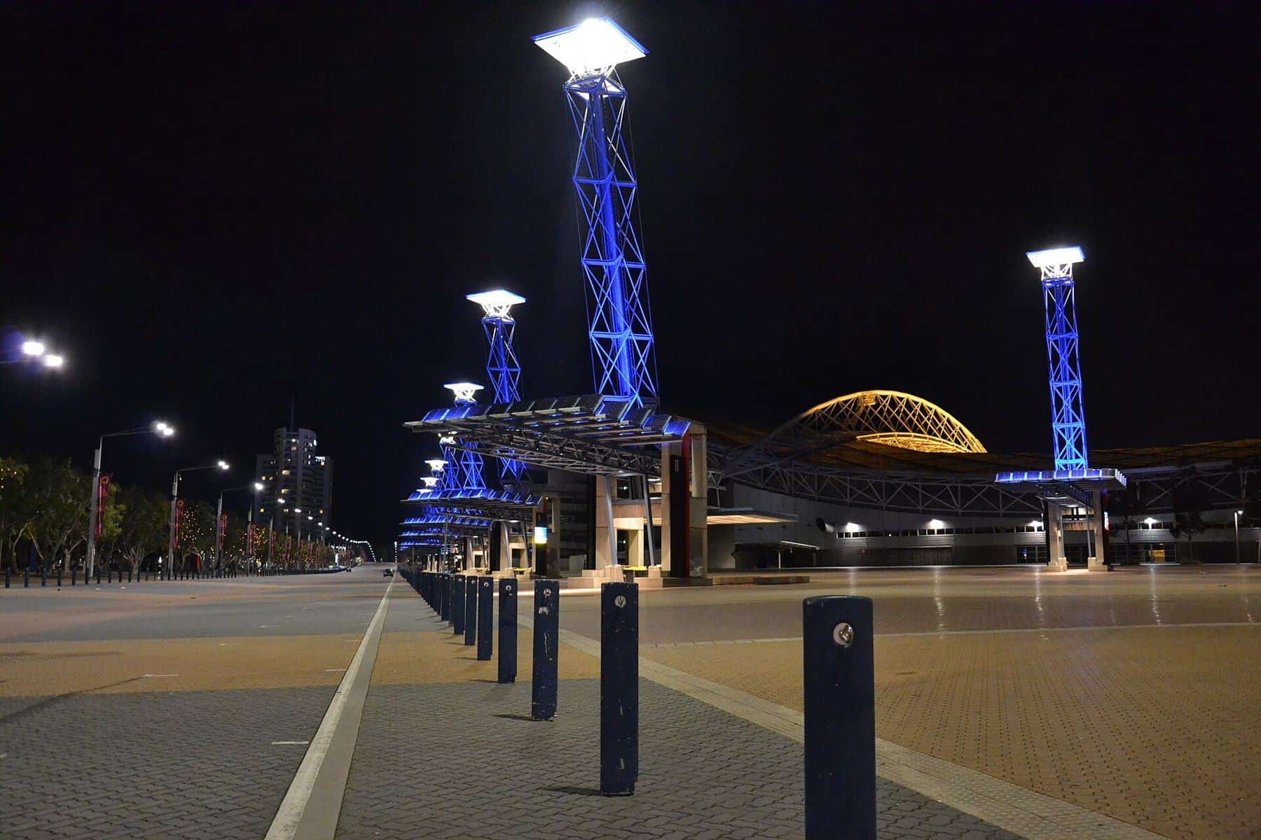 The wide pedestrian Olympic Boulevard at Sydney Olympic Park at night