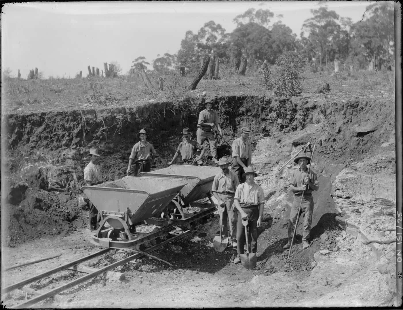 Historic photograph of workers and rail trucks at the State Brickworks, Homebush